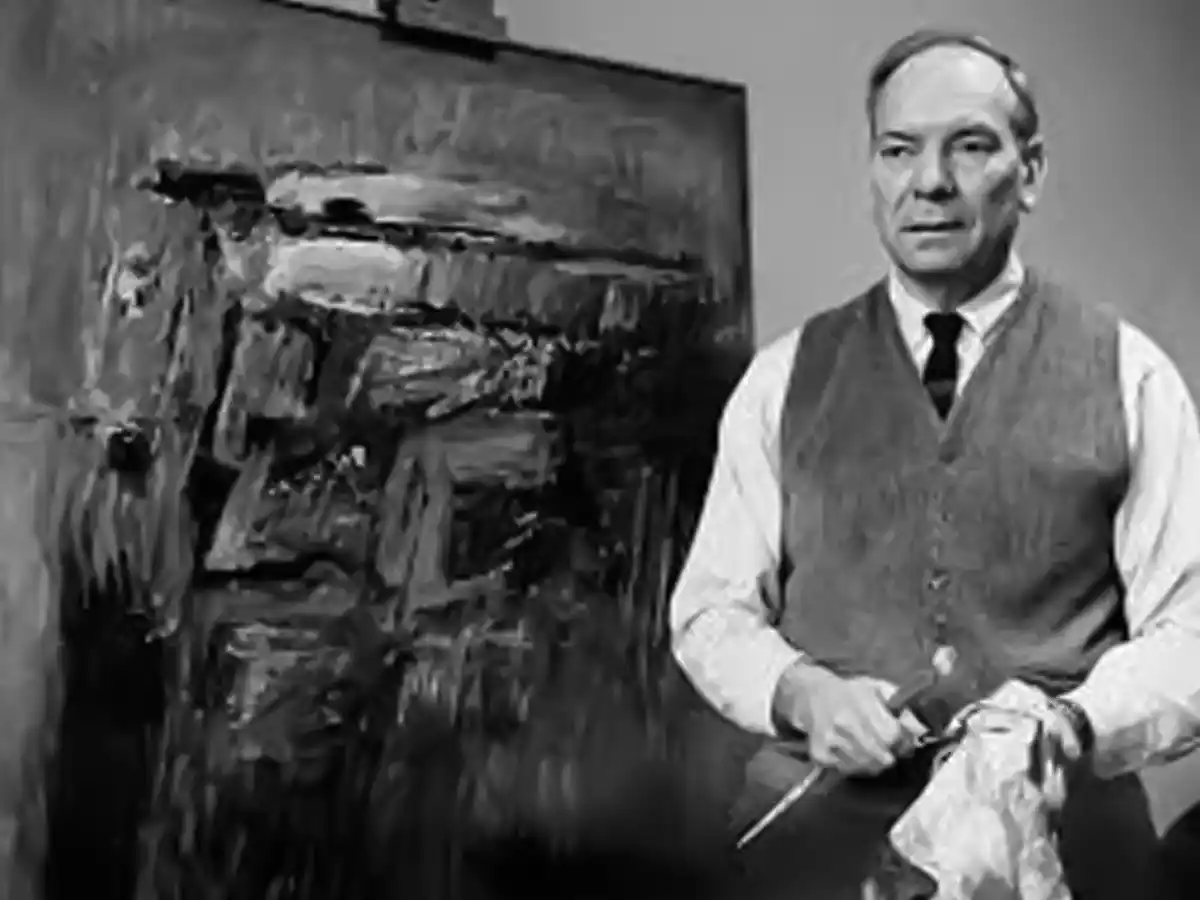 A photo of artist Carl Sublett with one of his paintings.