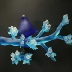A photo of Richard Jolley's glasswork entitled "Cobalt Dove on Aqua Branch Crystal Thistle"