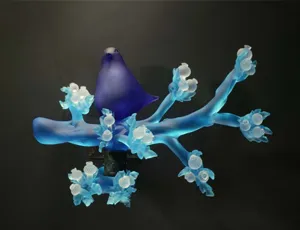 A photo of Richard Jolley's glasswork entitled "Cobalt Dove on Aqua Branch Crystal Thistle"